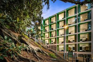 a building with green windows on a hill at Quest Mounts Bay Road in Perth