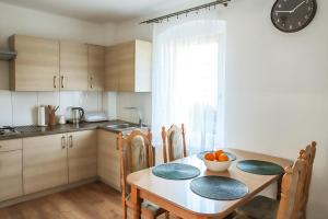 a kitchen with a table with a bowl of oranges on it at Tysiąclecia 11/1 in Piechowice