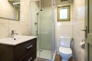a bathroom with a toilet and a glass shower at Chalet Renardeau - Sleeps 5 in Manhay +20 photos
