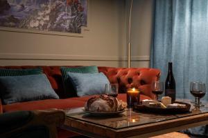 a living room with a red couch and a coffee table at My Boudoir in Paris +19 photos