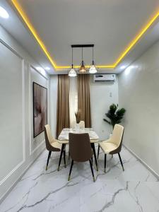 a dining room with a table and chairs at LinQues & Bethel Residences in Ibadan