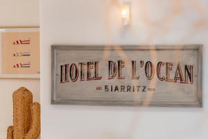 a sign that reads hotel de jogan on a wall at Hotel De L'Océan in Biarritz