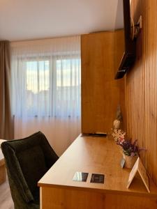 a room with a desk with a chair and a window at Infinity in Sibiu