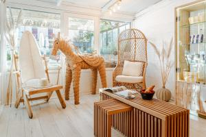 a room with a rocking horse and a table and chairs at Hotel de l'Océan et restaurant - Coeur de ville in Biarritz