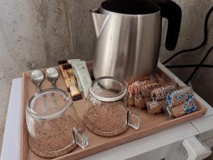 a cutting board with a coffee pot and some food at Stäy Hotel Nakijin in Nakijin
