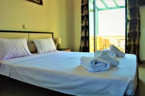 En eller flere senge i et værelse på Villa AlexandraSea View