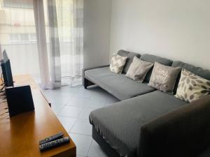 a living room with a couch and a table at SwordFish Fortress View in Peniche