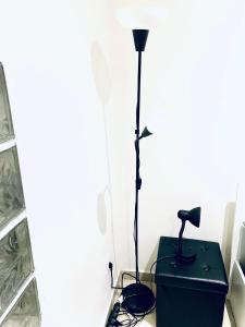 a black lamp sitting on top of a box at F2 Escale CDG calme à 20 mins de paris , Stade 2 France, Aéro CDG, Parc des expositions, Disneyland Paris,Futuroscope, Tour Eiffel in Arnouville-lès-Gonesse