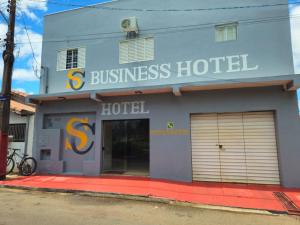 a blue building with a s business hotel at Suite Campina - Business Hotel in Campina do Monte Alegre