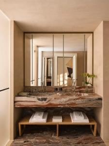 a bathroom with a large sink and a large mirror at VISTA Ostuni in Ostuni