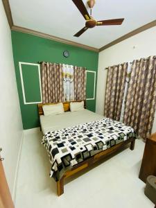 a bedroom with a bed and a ceiling fan at AL MANAL K-002 Premium 2BHK Retreat in Bhatkal