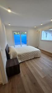 a bedroom with a bed and a large window at Villa Mar y Luna in Lignano Sabbiadoro
