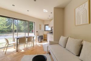 a living room with a couch and a table at Résidence moderne avec appartements lumineux et rénovés aux portes de Lyon in Écully