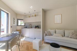 a living room with a couch and a table at Résidence moderne avec appartements lumineux et rénovés aux portes de Lyon in Écully +11 photos