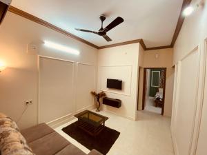 a living room with a couch and a ceiling fan at AL MANAL K-002 Premium 2BHK Retreat in Bhatkal +6 photos