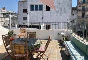 a patio with a table and chairs on a balcony at Casa Zefiro by Rentbeat in Ostuni +18 photos