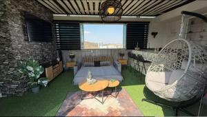 a living room with a bed and a table and chairs at Chalet Saint Lawrence GDL in Guadalajara +18 photos