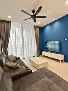 a living room with a couch and a ceiling fan at Podium 3BR 2BH Modern Homestay Near Aeon in Kuching