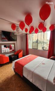 a bedroom with red balloons hanging from the ceiling at Hostal Paris MYP 3 in Lima