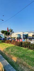 a park with a field of grass and a building at Hostal Paris MYP 3 in Lima