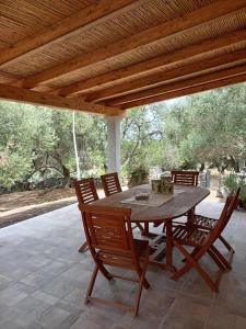 a wooden table and chairs on a patio at Stazzu Spadulagliu near Olbia in Telti