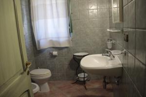 a small bathroom with a sink and a toilet at Stazzu Spadulagliu near Olbia in Telti +21 photos