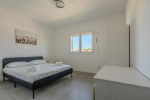 a bedroom with two beds and a window at Casa Dalia in Garbagnate Milanese