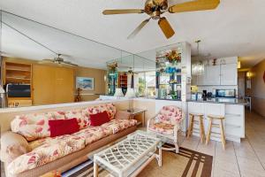 a living room with a couch and a kitchen at Island Sands Resort 103 in Maalaea