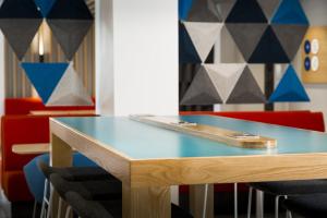 a table in a room with chairs and a wall at Holiday Inn Express St. Albans - M25, Jct.22 in Saint Albans