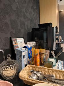 a counter top with a basket of food and a coffee maker at Hotel Lotus in Reykjavík