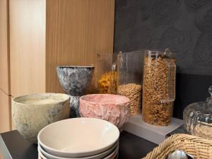 a group of bowls and vases sitting on a table at Hotel Lotus in Reykjavík