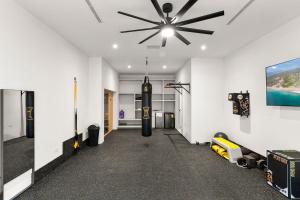 an empty hallway with a ceiling fan and a room with a game at Poco Paraiso in San José del Cabo