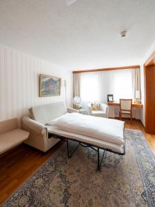a living room with a bed and a couch at Hotel Hecht in Appenzell
