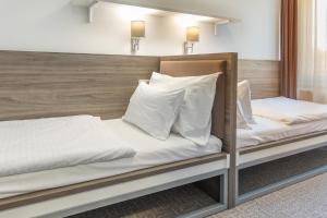 Una cama o camas en una habitación de Airport Hotel - Check-in Nonstop