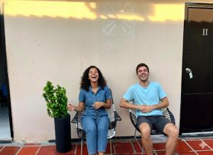 a man and a woman sitting in chairs at Hotel candilejas serenity in Barrancabermeja