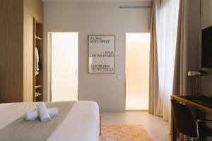 a bedroom with a bed with two towels on it at Outsite Barcelona - Work, Connect, Explore in Barcelona