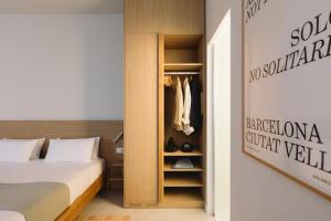 a bedroom with a bed and a closet at Outsite Barcelona - Work, Connect, Explore in Barcelona