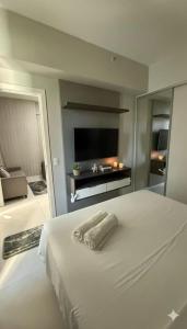 En eller flere senge i et værelse på Bahia Astron Flat Mundial