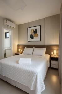 En eller flere senge i et værelse på Bahia Astron Flat Mundial