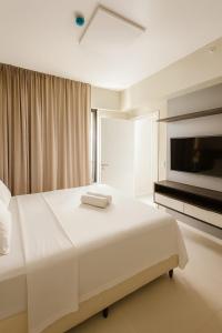 En eller flere senge i et værelse på Bahia Astron Flat Mundial + 4 billeder