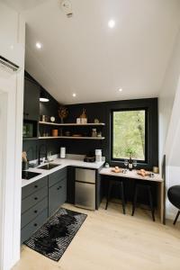 a kitchen with a sink and a window in it at The Alto in Logan +19 photos