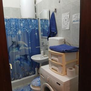 a bathroom with a washing machine and a sink at Tali in Novi Sad