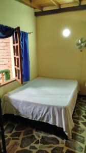 a small bed in a room with a window at Portal DCE in Envigado