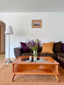 a living room with a coffee table and a couch at Apartments Gorje Hideaway in Spodnje Gorje +32 photos