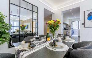 a dining room with a table and chairs at Kalm apartment- Luxury Living with a Gym, Heated Pool & Stunning Views in Nairobi