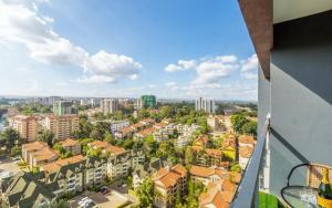 an apartment balcony with a view of a city at Kalm apartment- Luxury Living with a Gym, Heated Pool & Stunning Views in Nairobi
