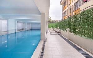 a swimming pool on the side of a building at Kalm apartment- Luxury Living with a Gym, Heated Pool & Stunning Views in Nairobi