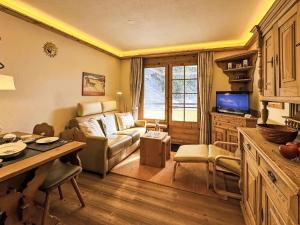 a living room with a couch and a table at Apartment Chesa Alvetern 5 by Interhome in Sils Maria