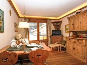 a kitchen with a table and chairs in a room at Apartment Chesa Alvetern 5 by Interhome in Sils Maria