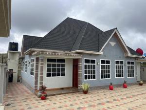 a house with a gray roof on a courtyard at Famurest in Nkoanrua